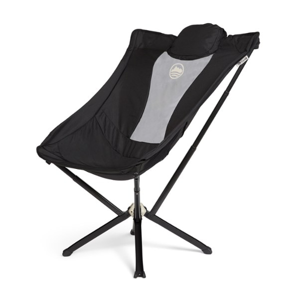 Side view of CLIQ TrailEase Reclining Chair set up at a forest campsite, showcasing portable chair design and aluminum frame.