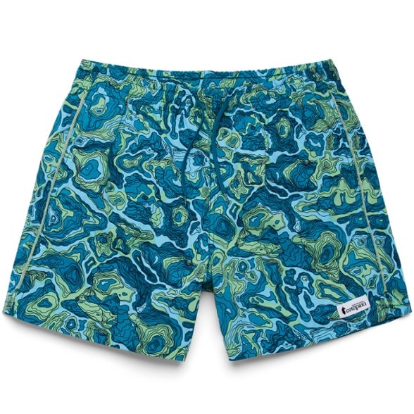 Front view of men's quick-dry shorts in a natural outdoor setting, showing pocket details and fabric texture.