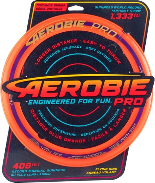 Aero Pro Flying Disc in flight over an open field, demonstrating its long-distance throwing capability.