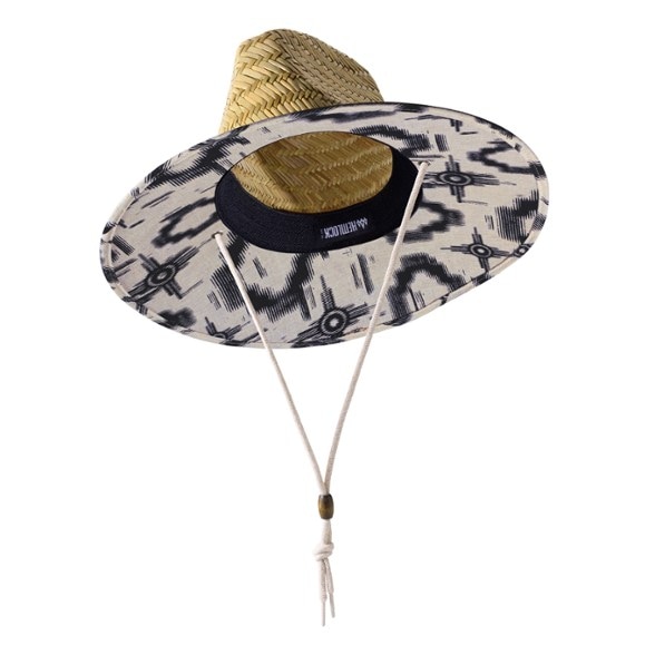 Nomad UPF 50+ hiking hat worn on a sunny trail, showcasing the wide brim and adjustable drawstring
