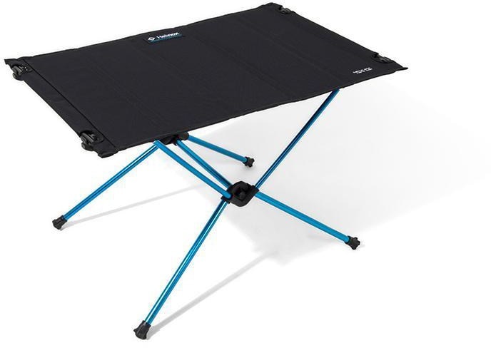 Portable camping table with hard top in use at a outdoor campsite