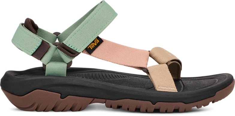 Side view of women's Teva Hurricane XLT2 hiking sandals on rocky terrain.