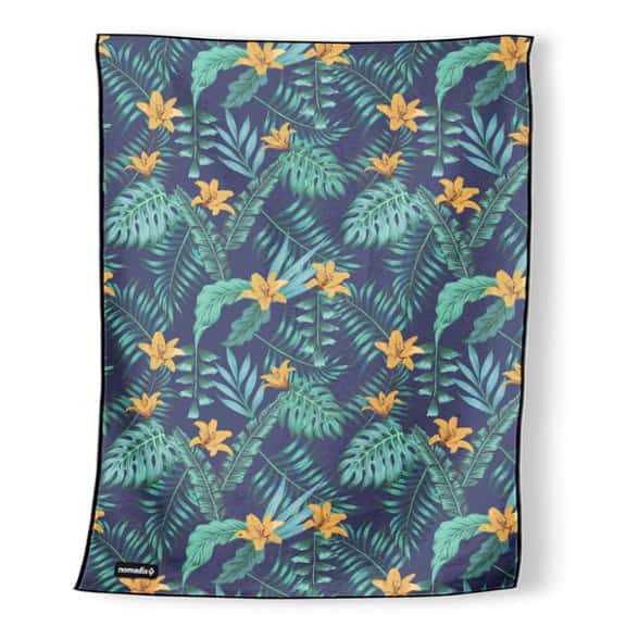 Family enjoying picnic on oversized Nomadix beach blanket towel