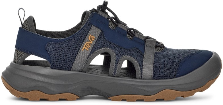 A pair of Teva Outflow CT men's hiking sandals, showcasing the closed-toe design and breathable mesh upper on a rocky, wet surface.