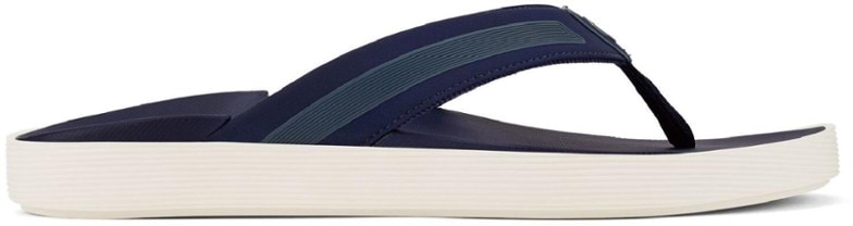 OluKai Leeward Comfort Sandals for Men in a stylish outdoor setting, emphasizing their lightweight design and cushioning.